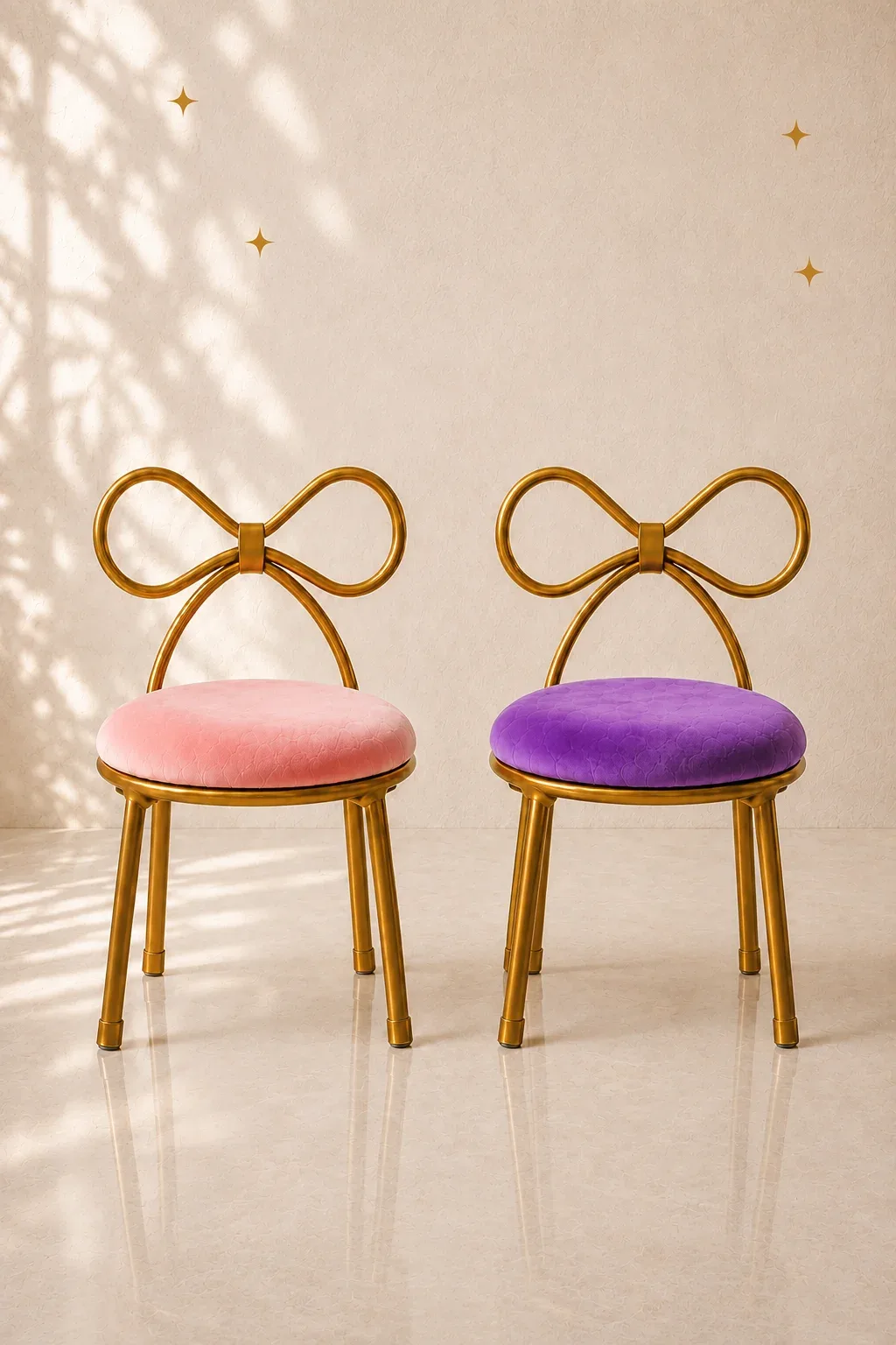 Two gold chairs with bow-shaped backs, one with a pink seat and one with a purple seat.