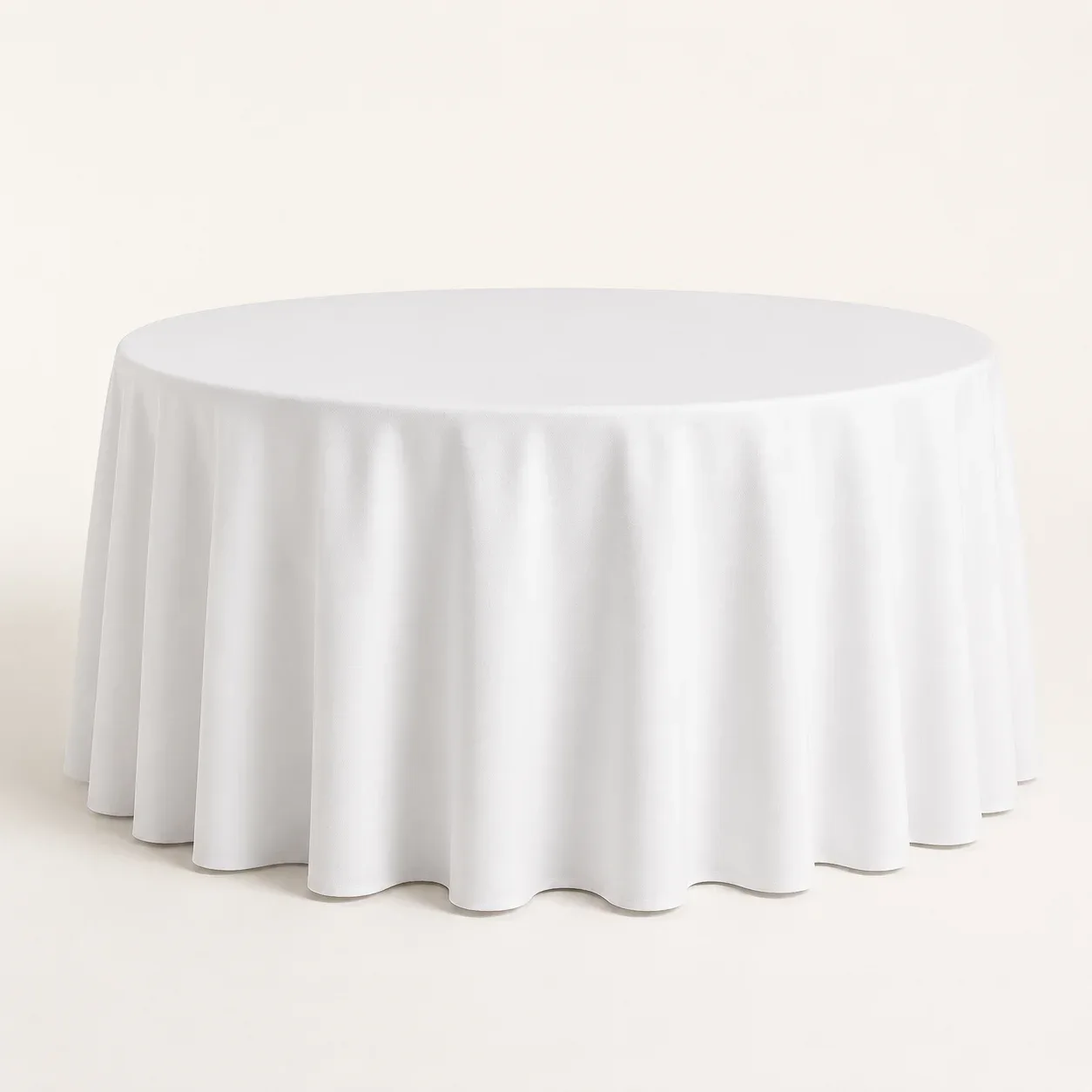 A round table covered with a white tablecloth.