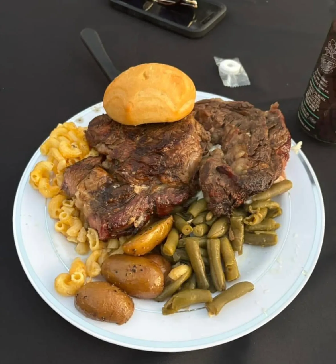 A plate of grilled steak and sides at the Steers & Beers fundraiser